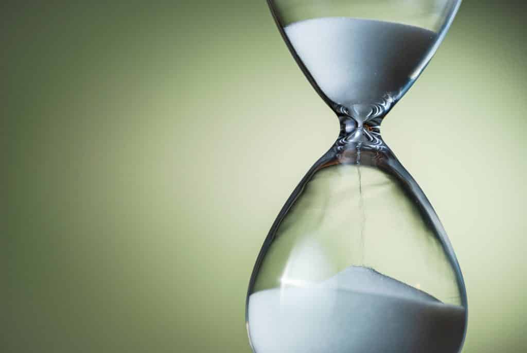 Sand running through the bulbs of an hourglass