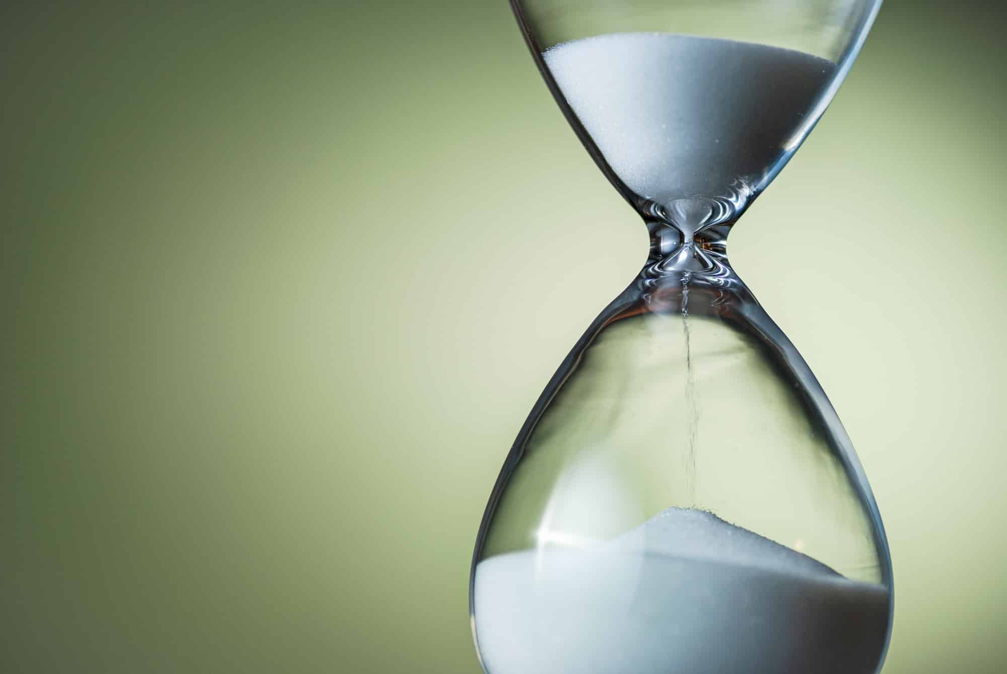 Sand running through the bulbs of an hourglass