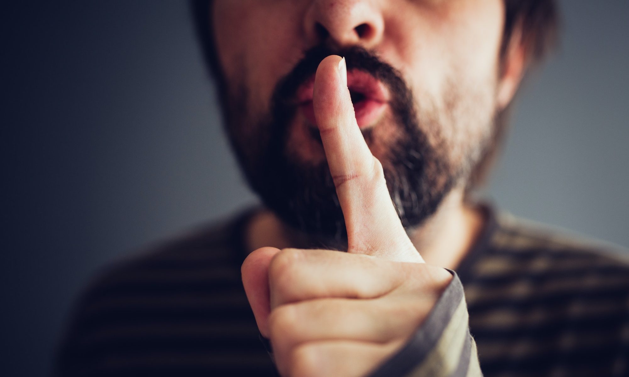 Man saying hush or be quiet